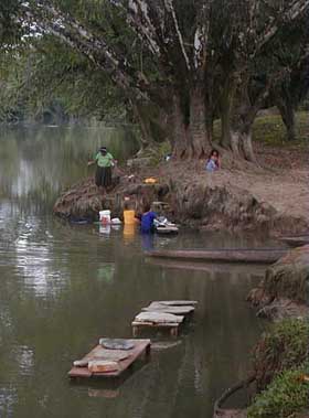 Maya women washing clothes in the Moho River near the village Santa Ana